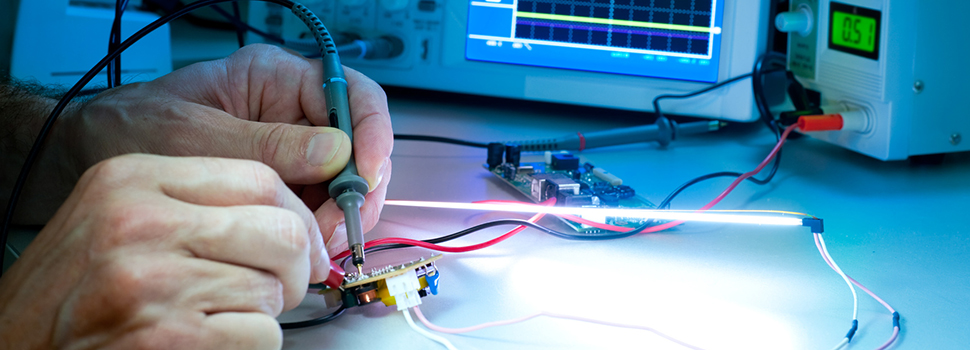 Tech tests electronic equipment in service centre